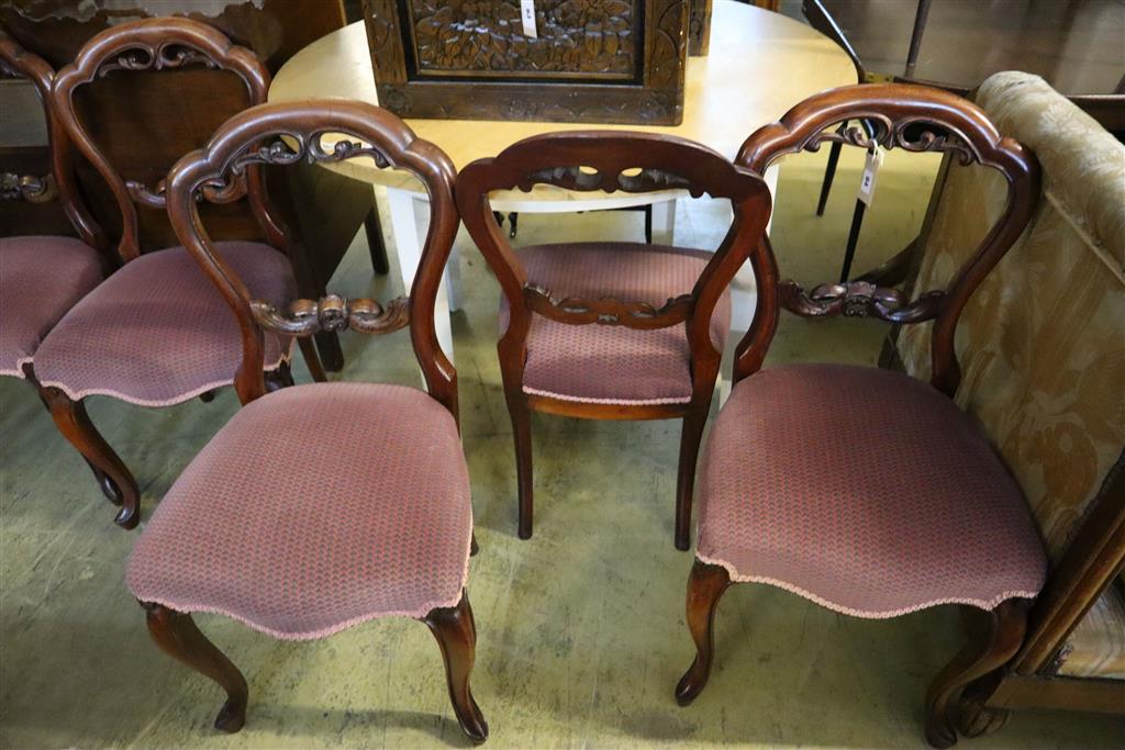 A set of six Victorian style mahogany balloon-back dining chairs, with stuffover seats on cabriole legs